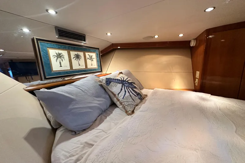 Loca Louise Yacht Photos Pics Luxurious bedroom interior of 2002 Hatteras 50 Convertible Sportfish yacht with elegant decor.