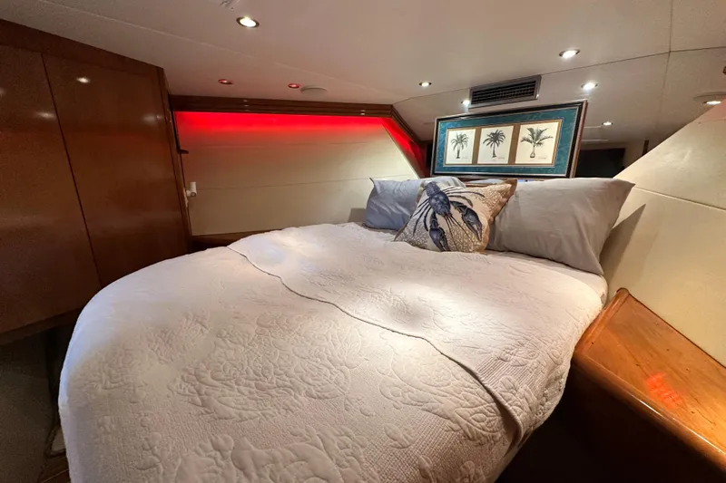Loca Louise Yacht Photos Pics Luxurious bedroom interior of 2002 Hatteras 50 Convertible Sportfish yacht with elegant decor.