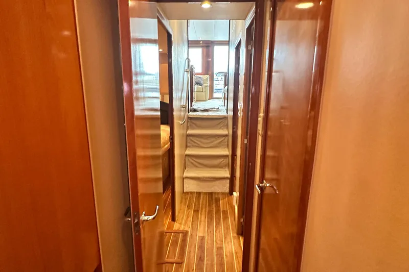 Loca Louise Yacht Photos Pics Interior hallway of 2002 Hatteras 50 Convertible Sportfish yacht with wooden flooring.