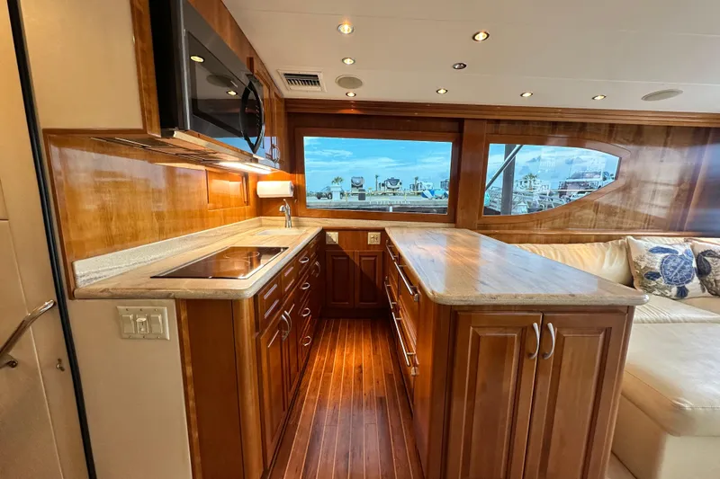 Loca Louise Yacht Photos Pics Luxurious kitchen interior of 2002 Hatteras 50 Convertible Sportfish yacht with wood cabinetry.