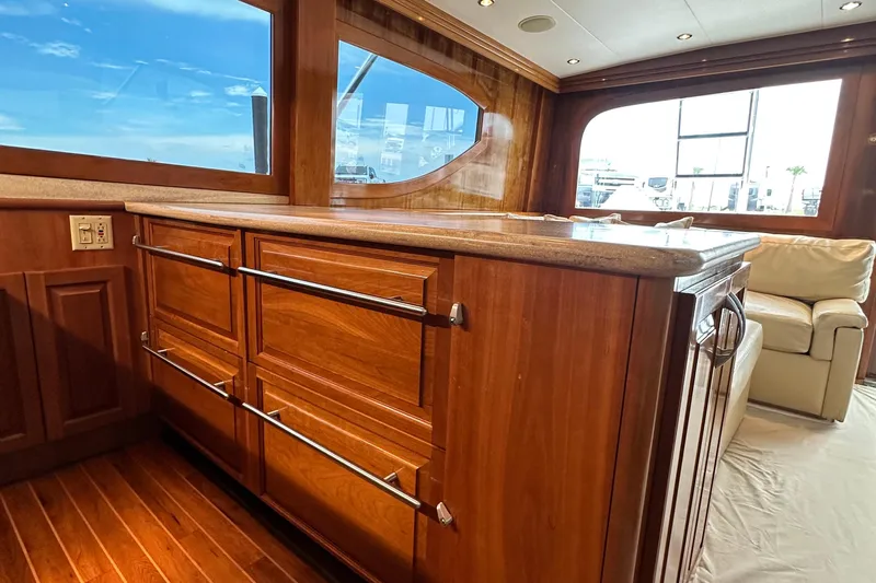 Loca Louise Yacht Photos Pics Luxurious interior of 2002 Hatteras 50 Convertible Sportfish with wooden cabinetry and plush seating.
