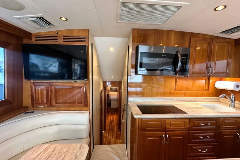 Loca Louise Yacht Photos Pics Interior of 2002 Hatteras 50 Convertible Sportfish with kitchen and seating area.