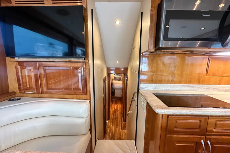 Loca Louise Yacht Photos Pics Interior of 2002 Hatteras 50 Convertible Sportfish with modern kitchen and cozy seating area.