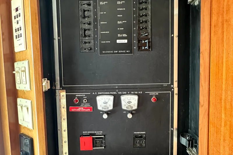 Loca Louise Yacht Photos Pics Electrical panel on 2002 Hatteras 50 Convertible Sportfish boat, featuring switches and gauges.