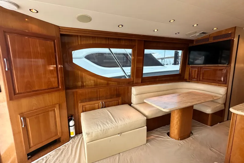 Loca Louise Yacht Photos Pics Luxurious interior of 2002 Hatteras 50 Convertible Sportfish yacht with wood finish and seating area.
