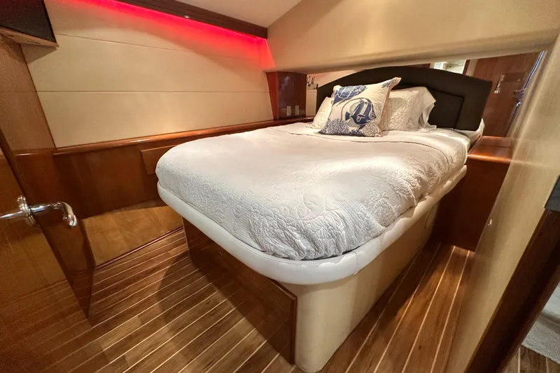 Loca Louise Yacht Photos Pics Luxurious bedroom interior of 2002 Hatteras 50 Convertible Sportfish yacht with elegant wood flooring.