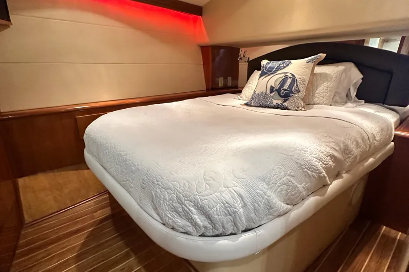 Loca Louise Yacht Photos Pics Luxurious bedroom interior of 2002 Hatteras 50 Convertible Sportfish yacht with elegant bedding.