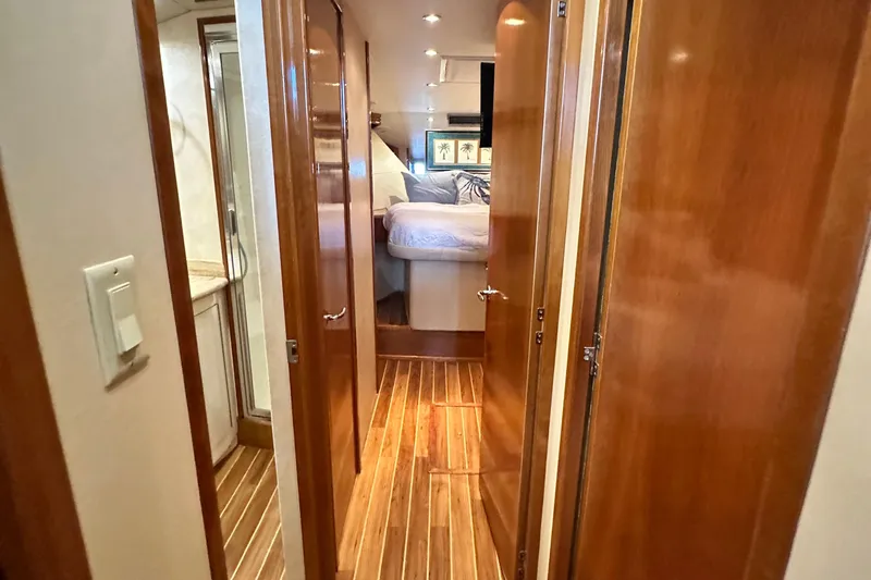 Loca Louise Yacht Photos Pics Interior of 2002 Hatteras 50 Convertible Sportfish, featuring wood paneling and cozy bedroom.