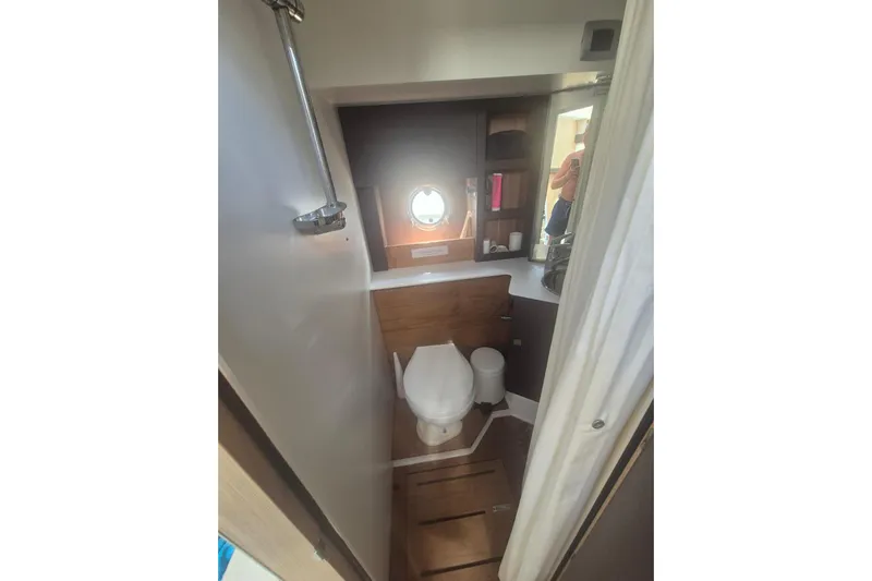  Yacht Photos Pics Bathroom interior of 2015 Cranchi M 44 HT yacht, featuring modern fixtures and wooden accents.