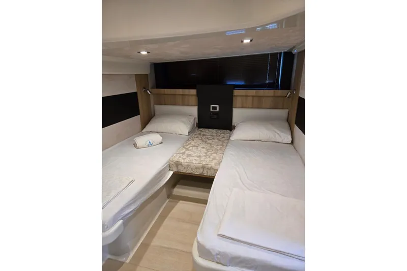  Yacht Photos Pics 2015 Cranchi M 44 HT yacht cabin with twin beds and modern decor.