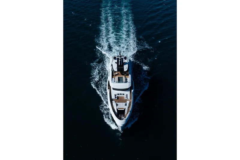  Yacht Photos Pics Aerial view of 2025 Baglietto DOM 133 yacht cruising on open water.