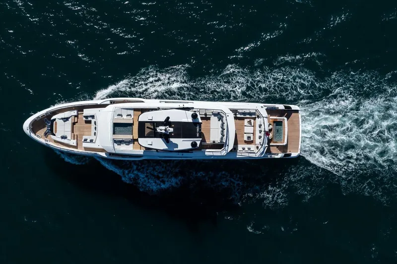  Yacht Photos Pics Aerial view of 2025 Baglietto DOM 133 yacht cruising on open water.