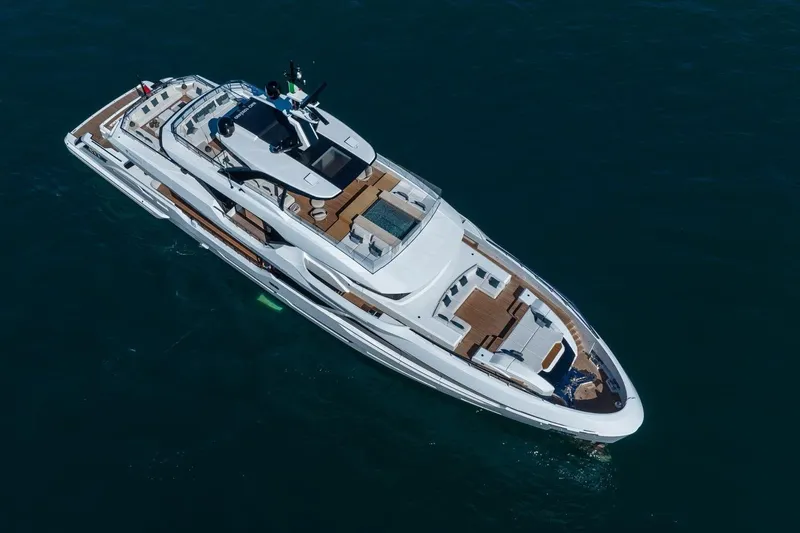  Yacht Photos Pics Aerial view of 2025 Baglietto DOM 133 luxury yacht cruising on open water.