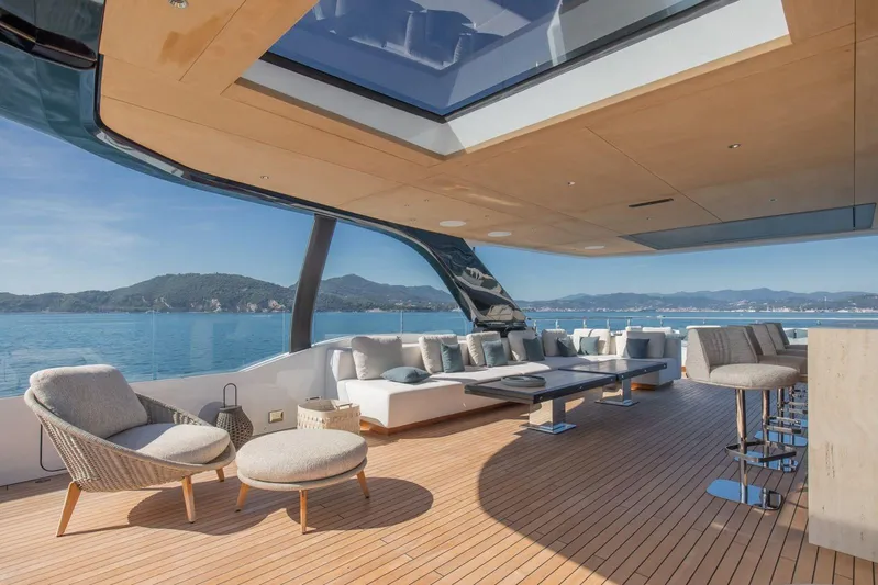  Yacht Photos Pics Luxurious 2025 Baglietto DOM 133 yacht deck with elegant seating and ocean view.