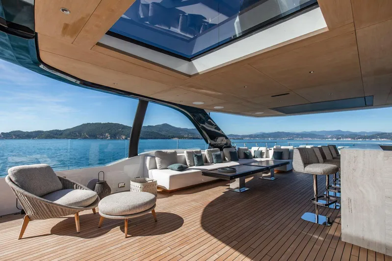  Yacht Photos Pics Luxurious 2025 Baglietto DOM 133 yacht deck with elegant seating and ocean view.