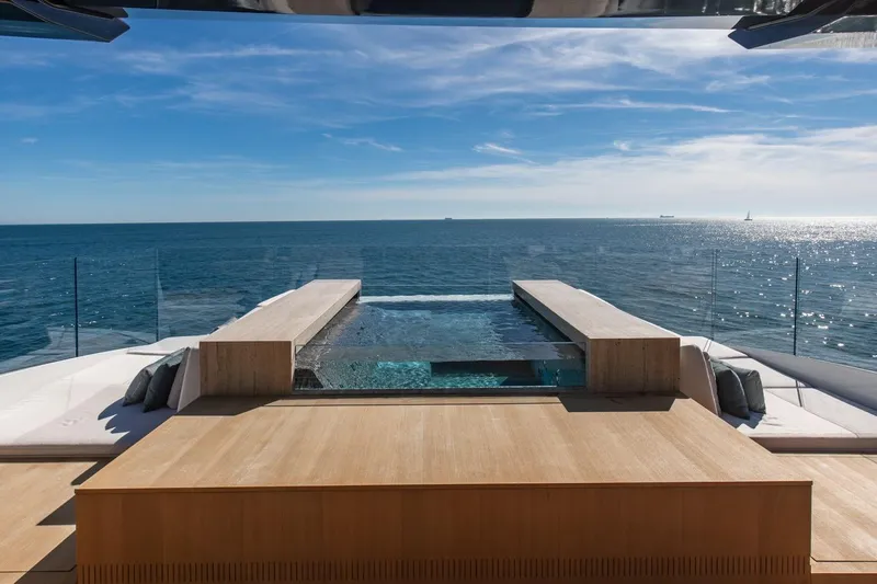  Yacht Photos Pics Luxurious Baglietto DOM 133 yacht deck with infinity pool, overlooking serene ocean view, 2025 model.