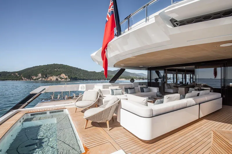  Yacht Photos Pics Luxurious 2025 Baglietto DOM 133 yacht deck with elegant seating and scenic ocean view.