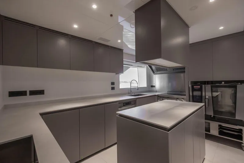  Yacht Photos Pics Modern kitchen interior on Baglietto DOM 133 yacht, 2025 model, featuring sleek cabinetry and appliances.