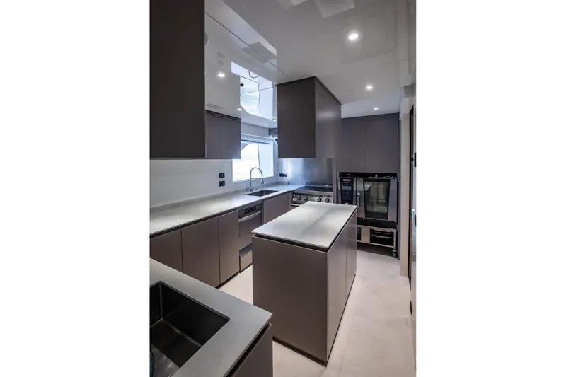  Yacht Photos Pics Modern kitchen interior on Baglietto DOM 133 yacht, 2025 model, featuring sleek cabinetry and appliances.