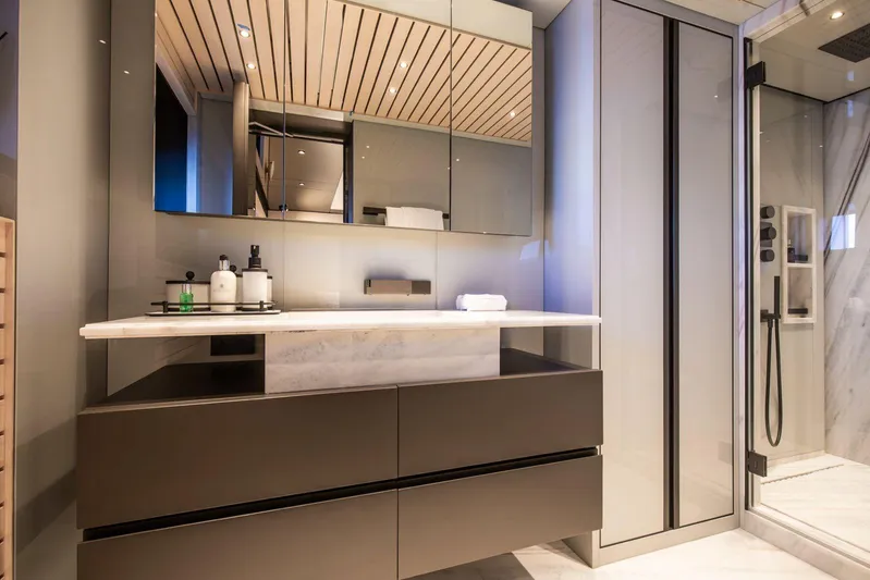  Yacht Photos Pics Luxurious bathroom interior on Baglietto DOM 133 yacht, featuring modern vanity and glass shower.