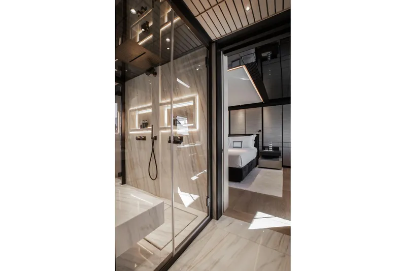  Yacht Photos Pics Luxurious interior of 2025 Baglietto DOM 133 yacht featuring modern shower and elegant bedroom.
