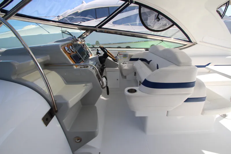  Yacht Photos Pics Interior of a 2012 Formula 400 Super Sport boat with white and blue seating.
