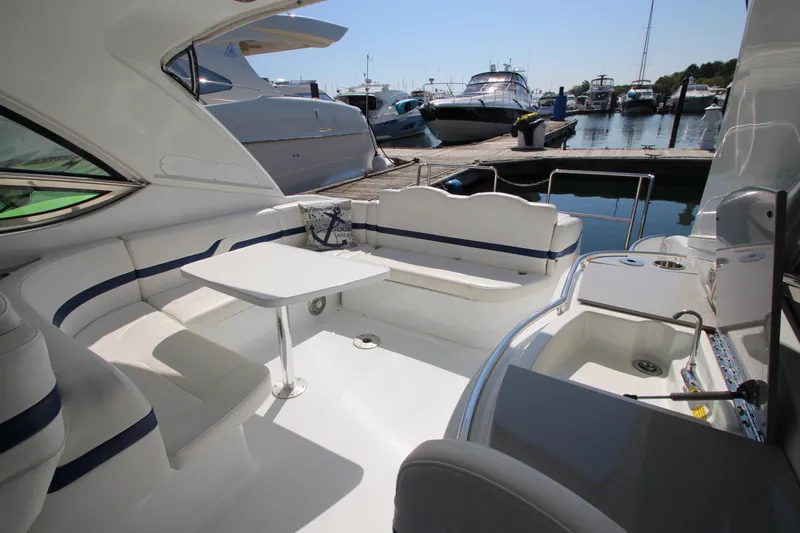  Yacht Photos Pics 2012 Formula 400 Super Sport yacht interior at marina, featuring seating and table.