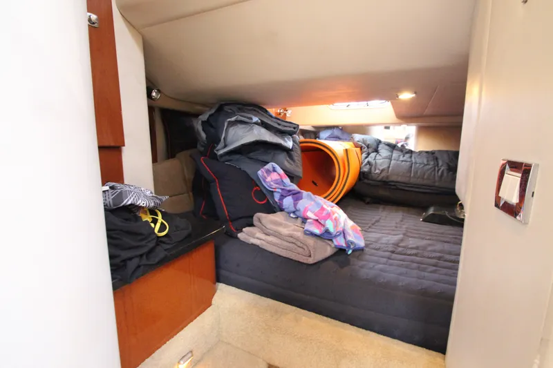  Yacht Photos Pics Interior cabin of a 2012 Formula 400 Super Sport boat with cluttered bedding.