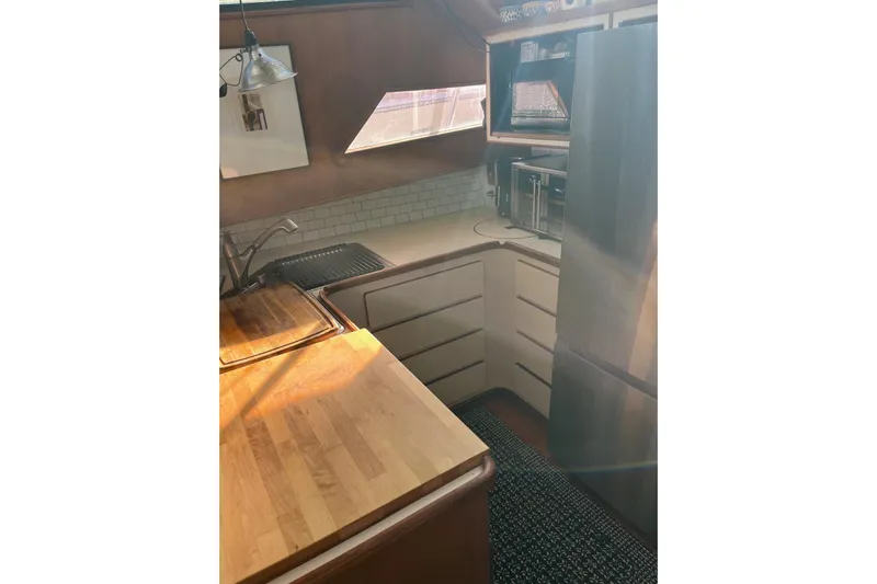  Yacht Photos Pics 1990 Mikelson 48 Sportfisher kitchen with wood countertops and modern appliances.