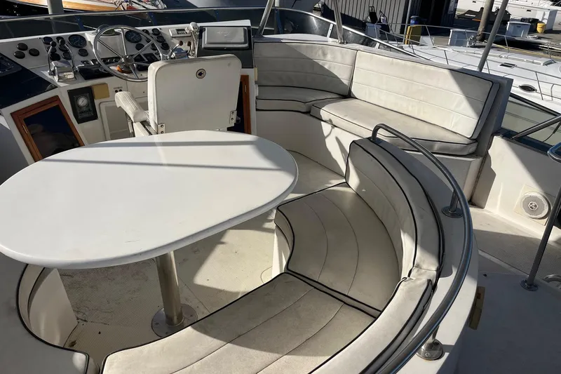  Yacht Photos Pics Interior of 1990 Mikelson 48 Sportfisher yacht with seating and helm.