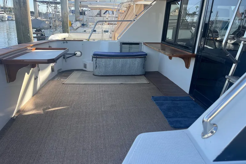  Yacht Photos Pics Spacious deck of 1990 Mikelson 48 Sportfisher yacht, featuring seating and storage.