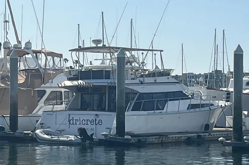  Yacht Photos Pics 1990 Mikelson 48 Sportfisher yacht docked at marina, surrounded by other boats.