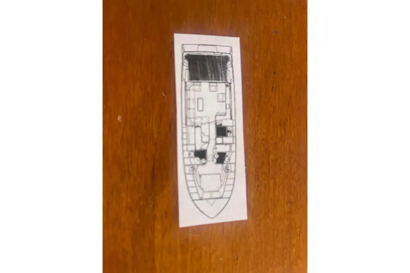  Yacht Photos Pics Blueprint of 1990 Mikelson 48 Sportfisher yacht on wooden surface.