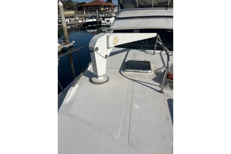  Yacht Photos Pics 1990 Mikelson 48 Sportfisher boat deck with davit crane and hatch.