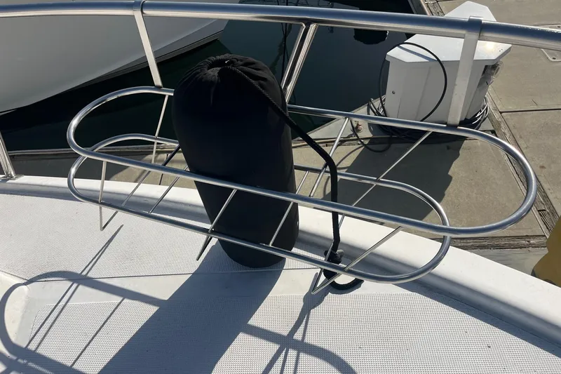  Yacht Photos Pics Bow of 1990 Mikelson 48 Sportfisher with fender and railing at dock.