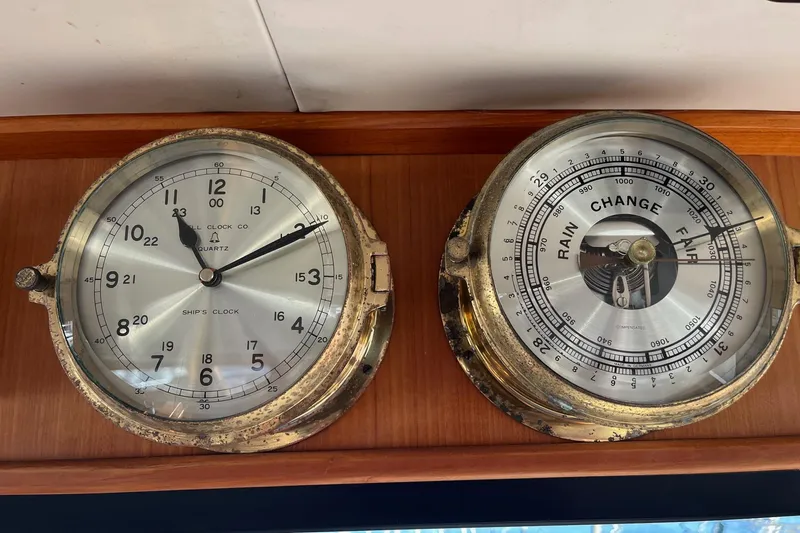  Yacht Photos Pics Vintage ship's clock and barometer on Mikelson 48 Sportfisher, 1990 model.