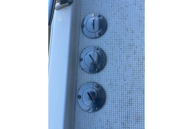  Yacht Photos Pics Three metal fuel caps on a 1990 Mikelson 48 Sportfisher boat deck.