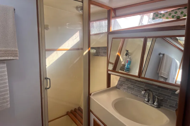  Yacht Photos Pics Bathroom interior of 1990 Mikelson 48 Sportfisher with shower and sink.