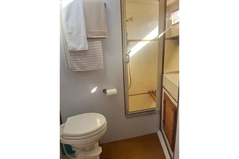  Yacht Photos Pics Bathroom interior of 1990 Mikelson 48 Sportfisher yacht with shower and toilet.
