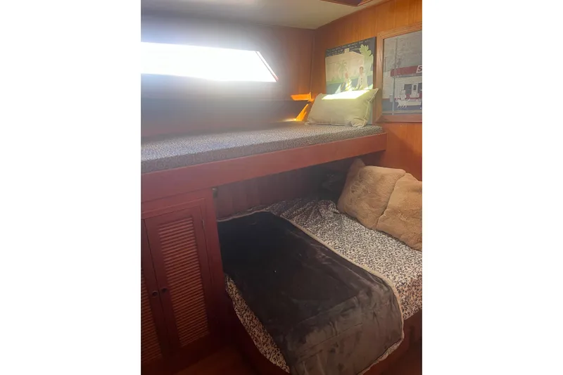  Yacht Photos Pics Cozy cabin interior of 1990 Mikelson 48 Sportfisher with bunk beds and soft lighting.