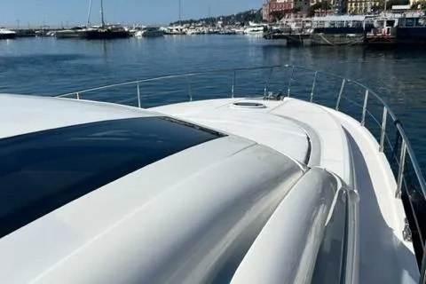  Yacht Photos Pics 2011 Pershing 50.1 yacht on calm waters, docked in a scenic marina.