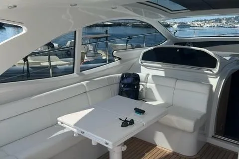 Yacht Photos Pics 2011 Pershing 50.1 yacht interior with white seating and table, docked at marina.