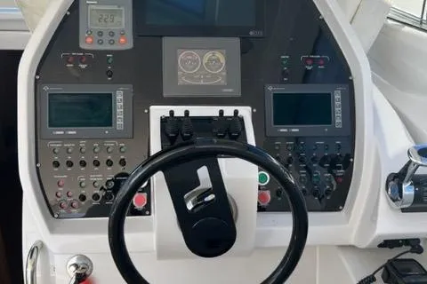  Yacht Photos Pics Control panel of a 2011 Pershing 50.1 yacht with steering wheel and navigation instruments.