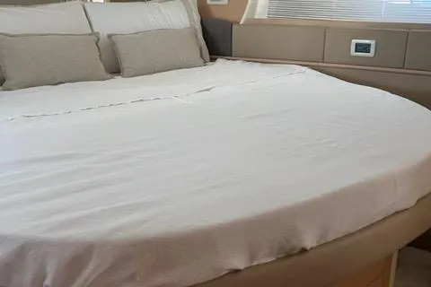  Yacht Photos Pics Luxurious bedroom interior of 2011 Pershing 50.1 yacht with plush bedding.