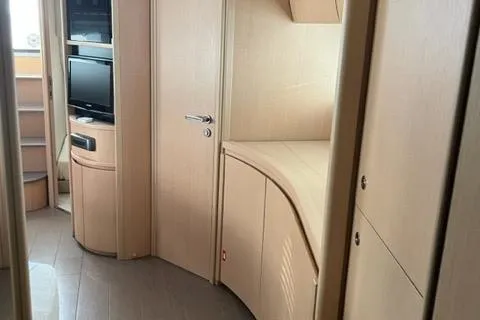  Yacht Photos Pics Interior of 2011 Pershing 50.1 yacht with modern wood finish and built-in TV.