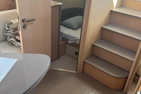  Yacht Photos Pics Interior of 2011 Pershing 50.1 yacht with stairs, table, and cozy cabin.