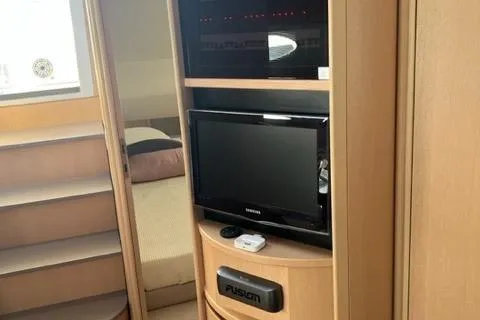  Yacht Photos Pics Interior of 2011 Pershing 50.1 yacht with TV and shelving unit.