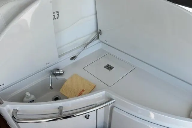  Yacht Photos Pics Compact sink area on 2011 Pershing 50.1 yacht with faucet and cleaning supplies.