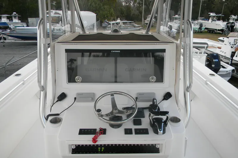  Yacht Photos Pics 2022 Contender 39 ST boat dashboard with Garmin navigation system and steering wheel.