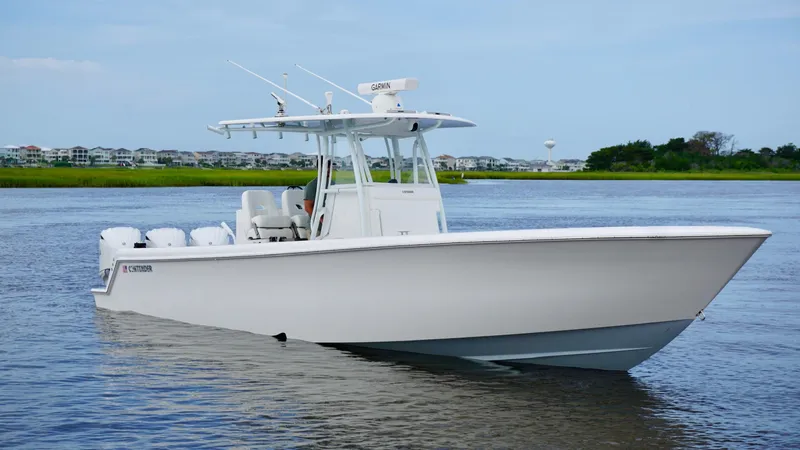  Yacht Photos Pics 2023 Contender 35 ST boat on calm water, featuring sleek design and triple engines.